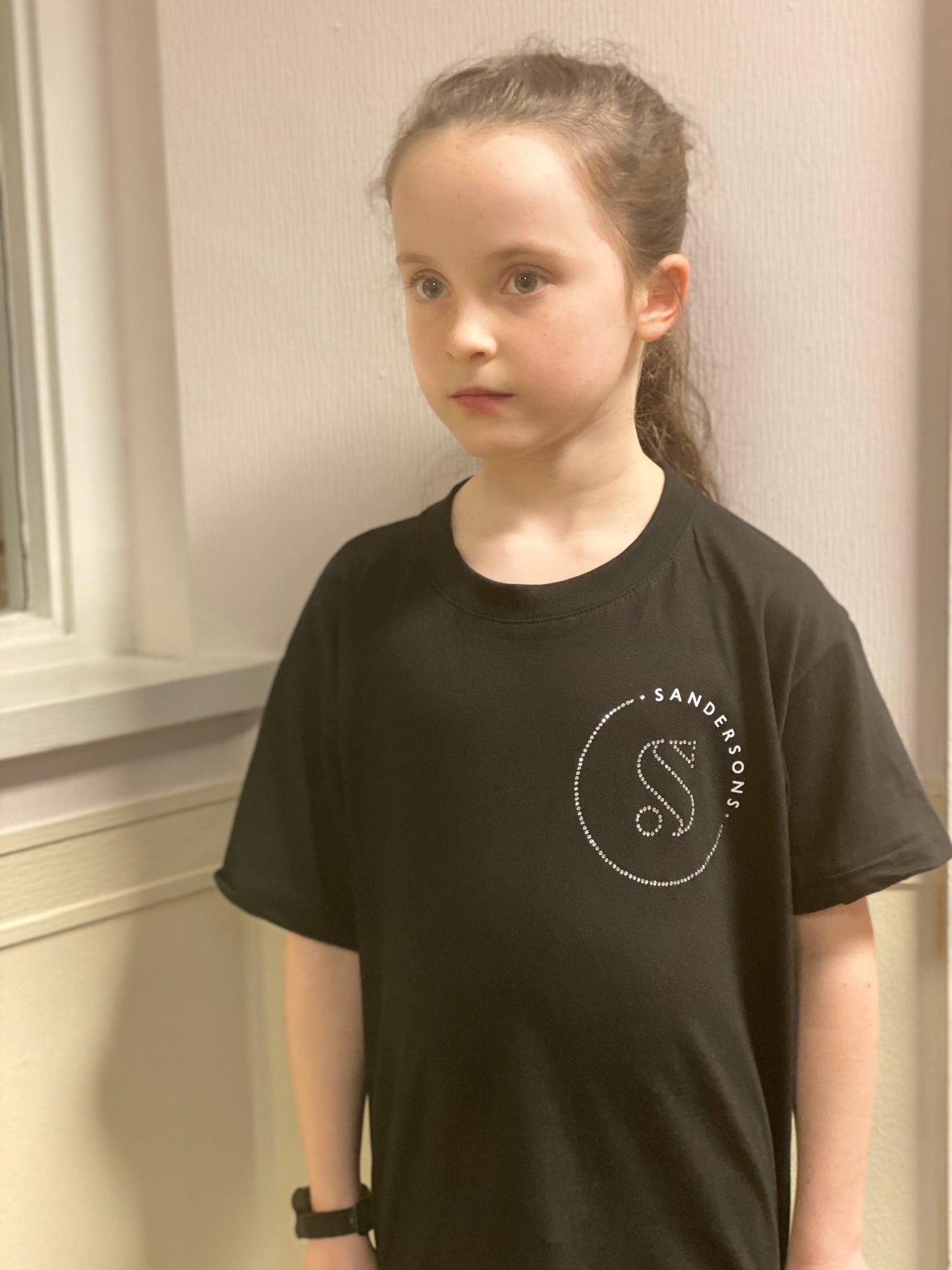 KIDS BLACK SANDERSONS T SHIRT BY AXZNT WITH SMALL BADGE WHITE/SILVER PRINT & STONES